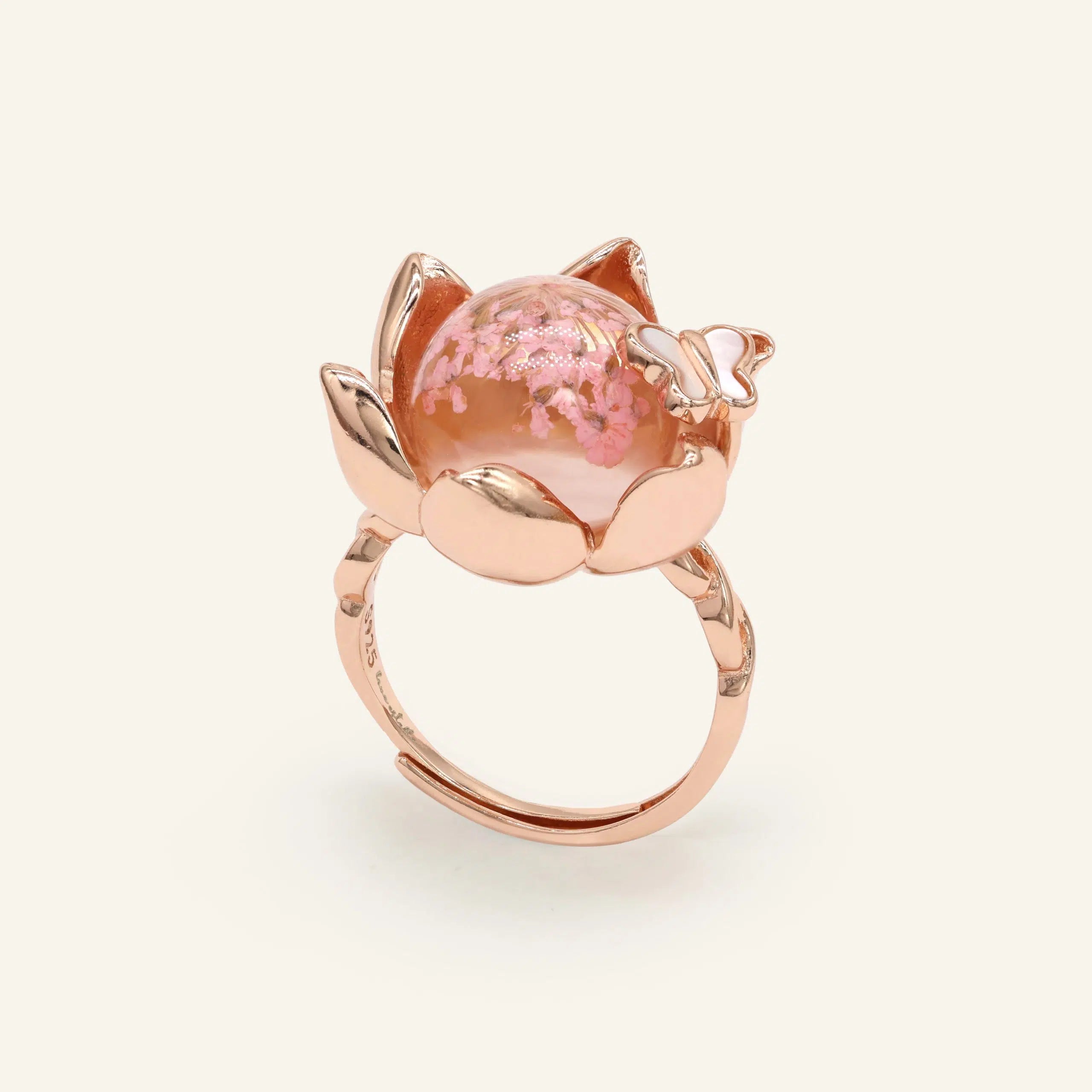 Close-up of a rose gold eternal bloom ring with sakura-like flowers