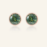 A pair of elegant earrings, each featuring a one carat green moissanite stone set in a bezel rose gold setting.