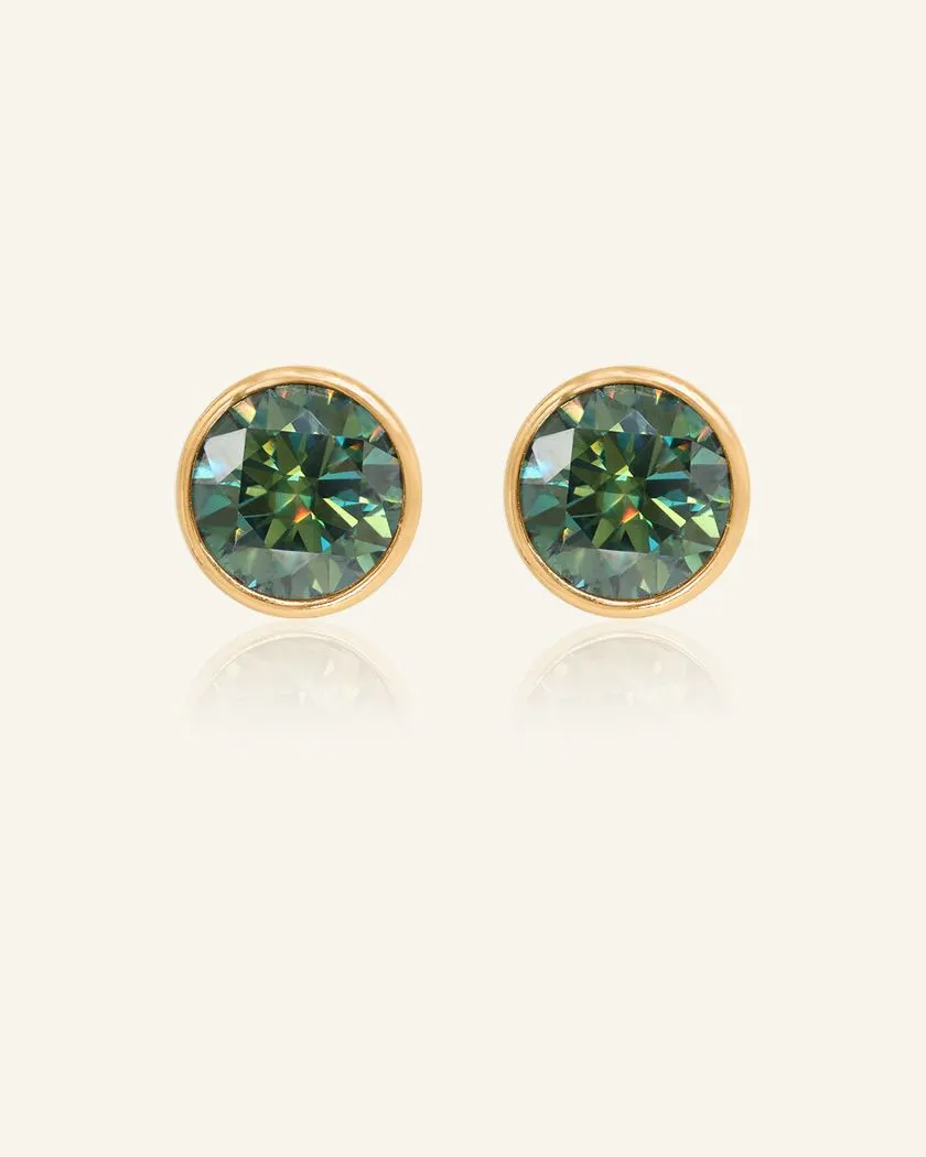 A pair of elegant earrings, each featuring a one carat green moissanite stone set in a bezel yellow gold setting.