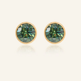 A pair of elegant earrings, each featuring a one carat green moissanite stone set in a bezel yellow gold setting.