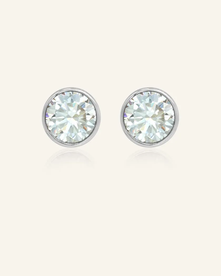 Elegant 1-carat Snow Blue Moissanite bezel studs set in silver, showcasing a brilliant icy sparkle and timeless design.