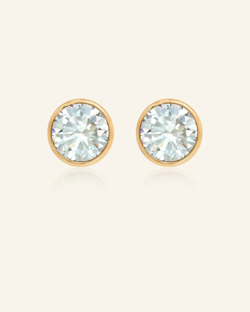 Elegant 1-carat Snow Blue Moissanite bezel studs set in yellow gold, showcasing a brilliant icy sparkle and timeless design.