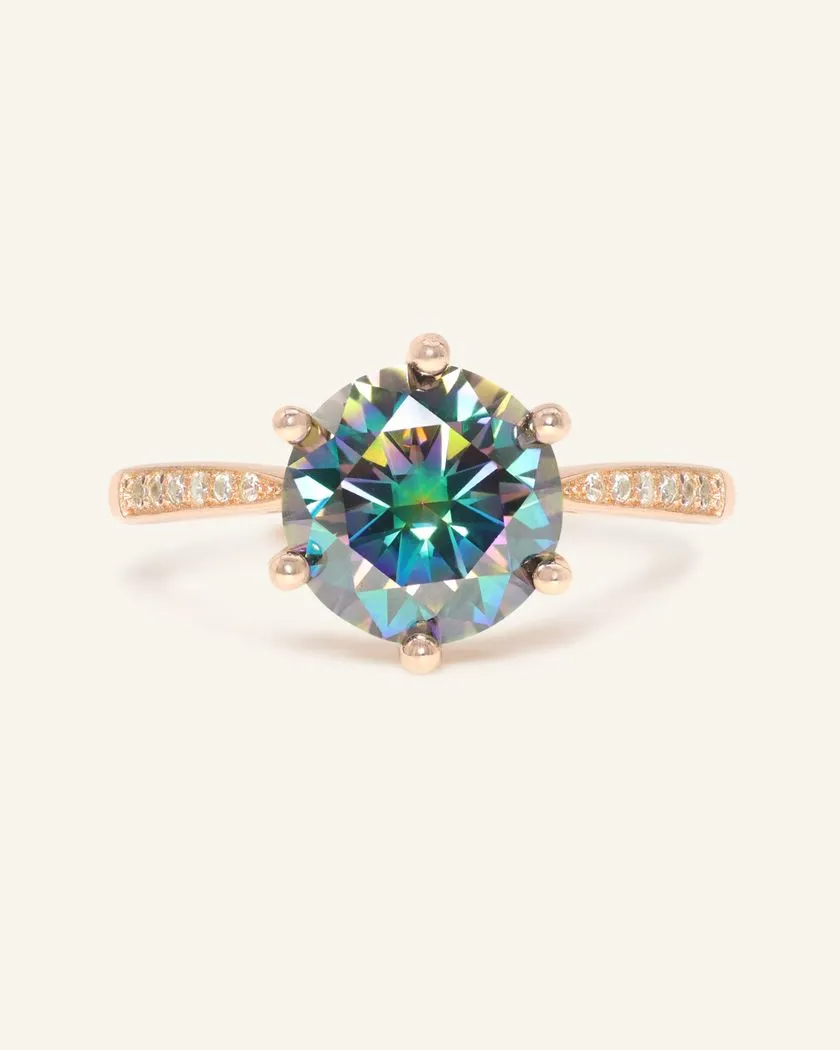 A stunning 3ct mystic moissanite ring featuring a large, vibrant, moissanite set in a rose gold band.