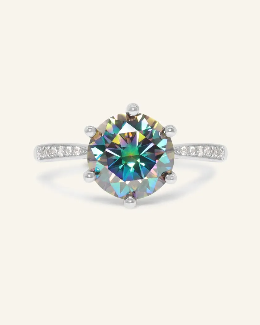 A stunning 3ct mystic moissanite ring featuring a large, vibrant, moissanite set in a silver band.