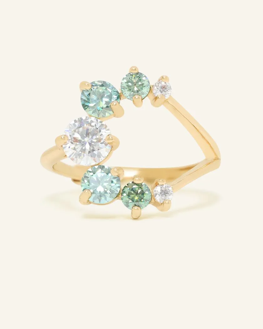 Elegant yellow gold moissanite ring featuring a central large moissanite stone surrounded by smaller green moissanite stones in a unique crescent design