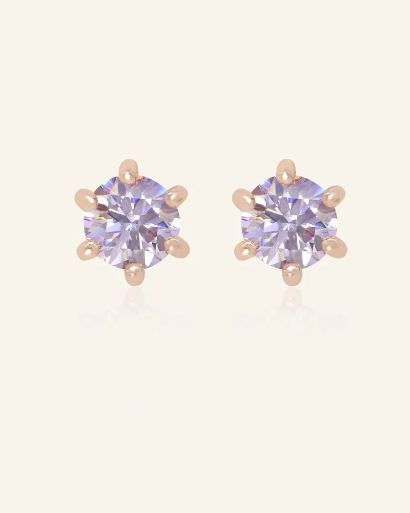 Dainty lilac moissanite studs set in rose gold, featuring a soft lavender sparkle and a six-prong design for an elegant and timeless look.