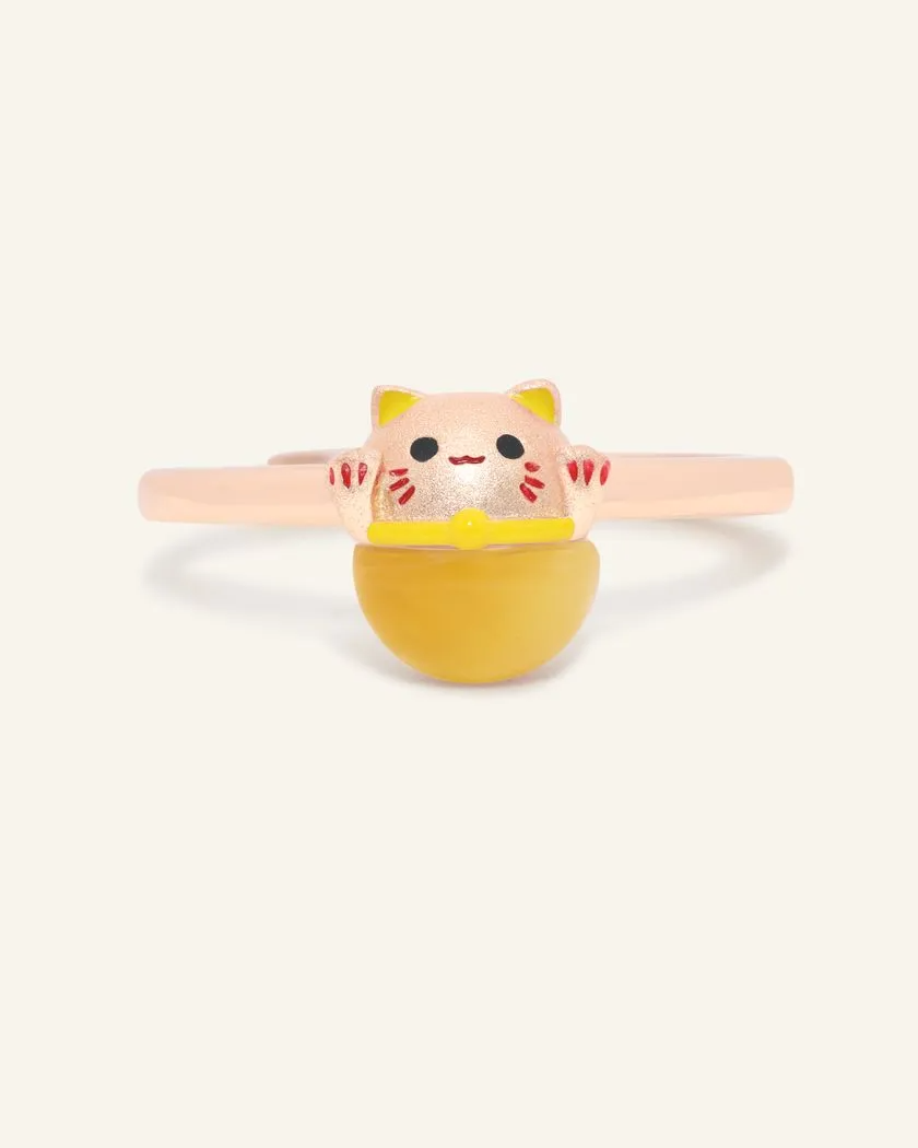 A Fortune Cat Ring featuring a cheerful design crafted in rose gold and set with a polished tiger eye gemstone. This playful piece symbolizes protection, positivity, and prosperity, making it a charming and meaningful accessory.