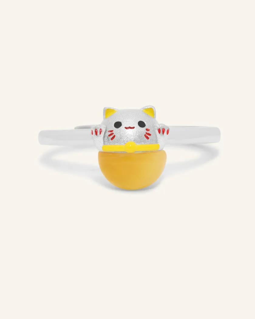 A Fortune Cat Ring featuring a cheerful design crafted in silver and set with a polished tiger eye gemstone. This playful piece symbolizes protection, positivity, and prosperity, making it a charming and meaningful accessory.