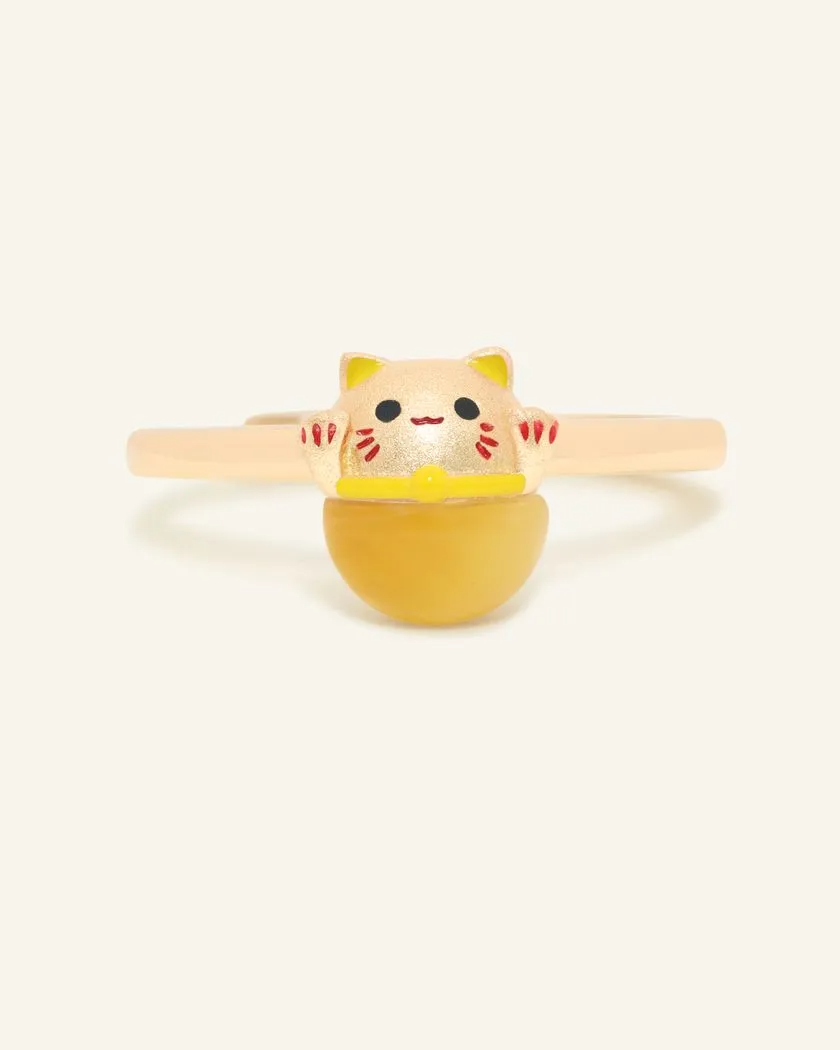A Fortune Cat Ring featuring a cheerful design crafted in yellow gold and set with a polished tiger eye gemstone. This playful piece symbolizes protection, positivity, and prosperity, making it a charming and meaningful accessory.	