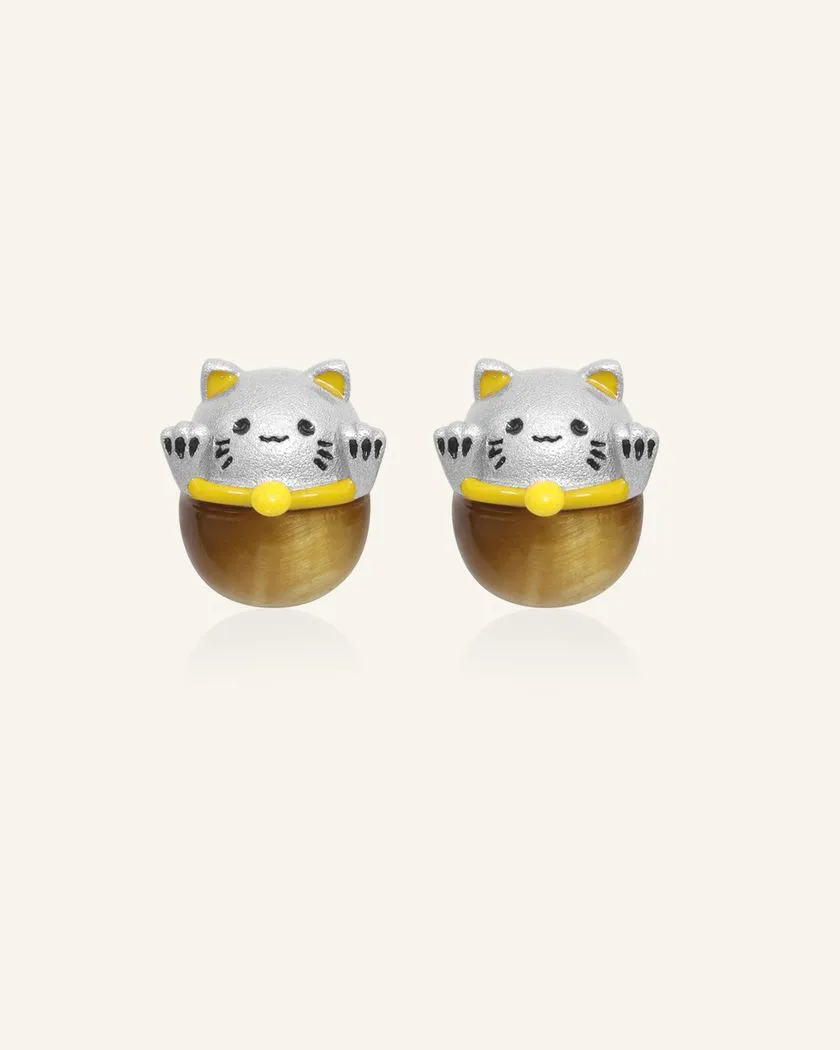 Silver fortune cat-inspired studs featuring adorable feline motifs, elegantly perched on polished tiger eye gemstones for a touch of charm and good fortune.