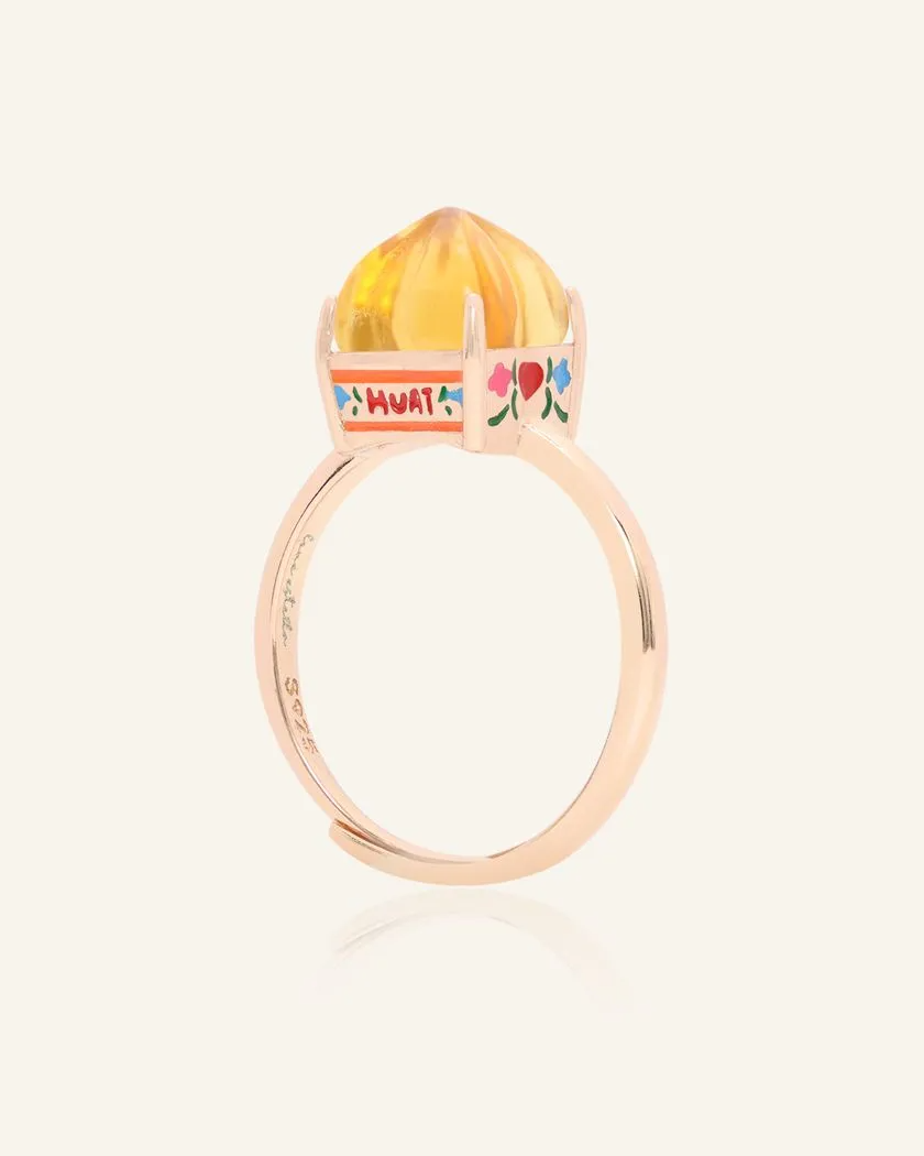 Rose gold Huat Kueh-inspired ring featuring a vibrant citrine gemstone as the steamed cake centerpiece, adorned with intricate enamel details, including 'Huat' and floral accents symbolizing prosperity and joy.