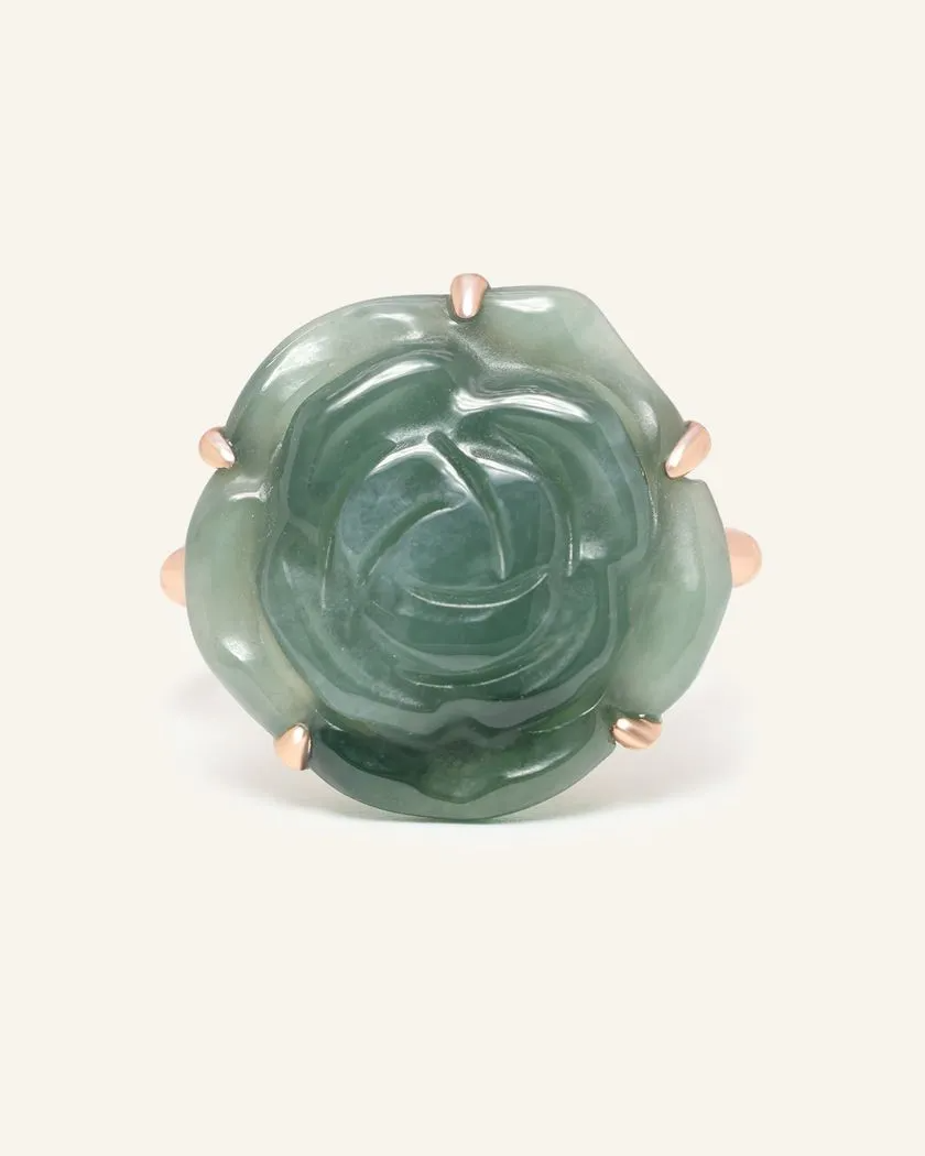 Handcarved jadeite rose ring set in rose gold, showcasing intricate detailing and natural stone patterns.	