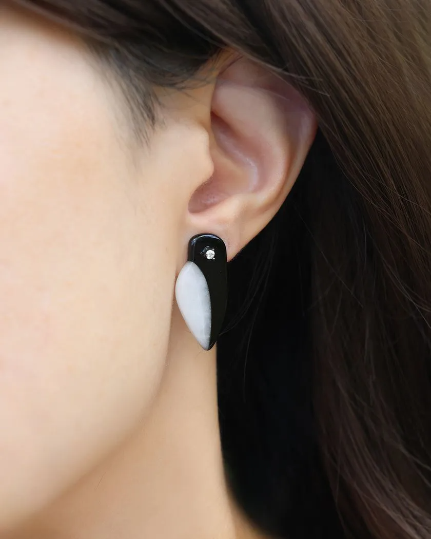 Penguin-shaped stud earrings, worn on the ear, crafted from polished agate, featuring a sparkling white moissanite eye.	