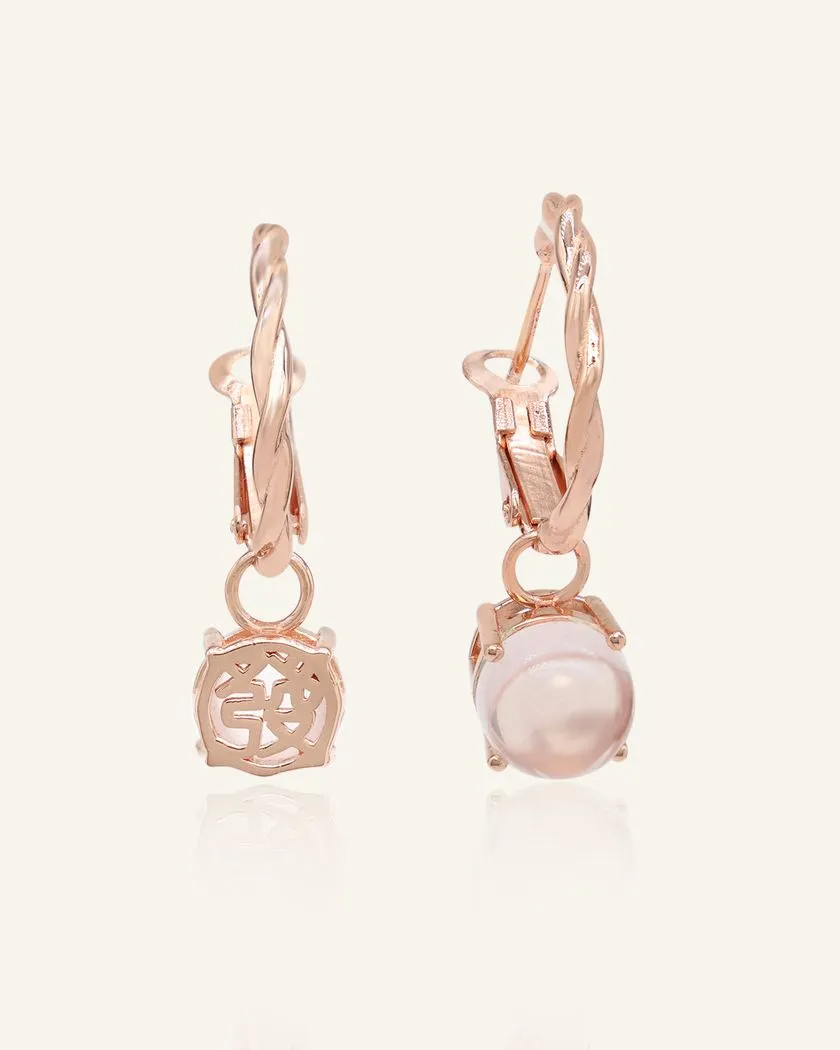 A pair of elegant rose gold hoop earrings, each featuring a dangling rose quartz stone.