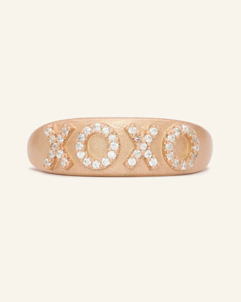 Rose gold XOXO ring with a matte finish, featuring sparkling cubic zirconia stones set in the letters for a chic and romantic touch.
