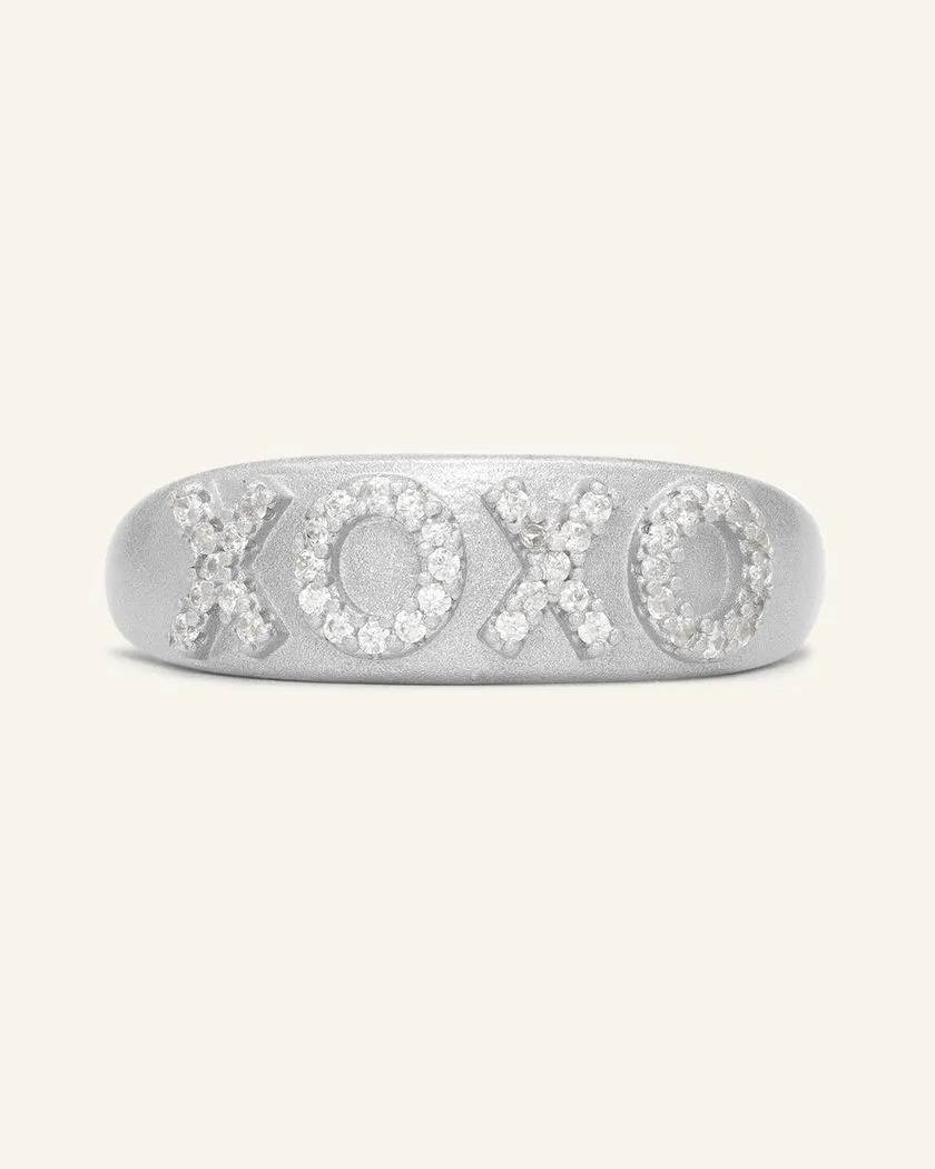 Silver XOXO ring with a matte finish, featuring sparkling cubic zirconia stones set in the letters for a chic and romantic touch.
