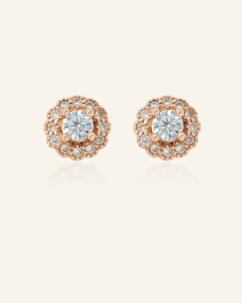 Chrome Grey Moissanite Halo Studs in Rose Gold – Elegant and timeless earrings featuring a sparkling whitish grey moissanite center stone, encircled by a radiant halo of cubic zirconia.