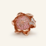 Close-up of a rose gold eternal bloom ring with sakura-like flowers